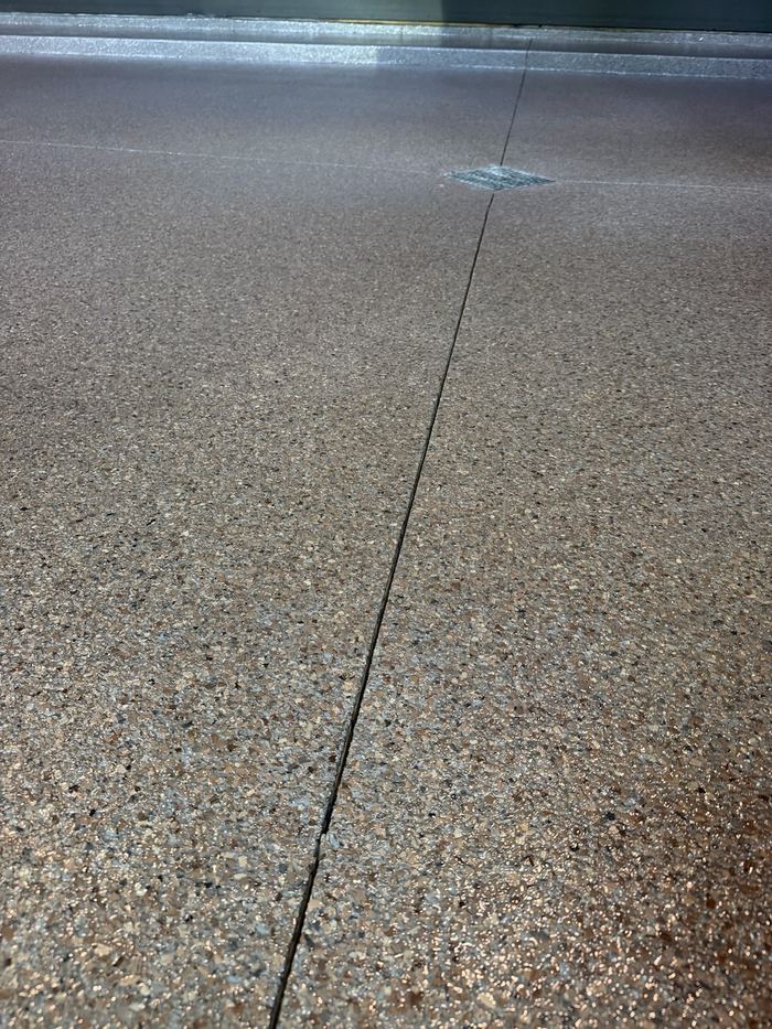 Multi-tone flake · wide bay — Signature Finishes concrete coating