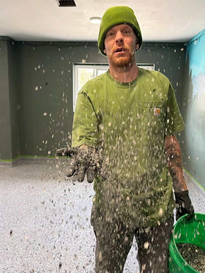 Broadcasting flake by hand — Signature Finishes concrete coating