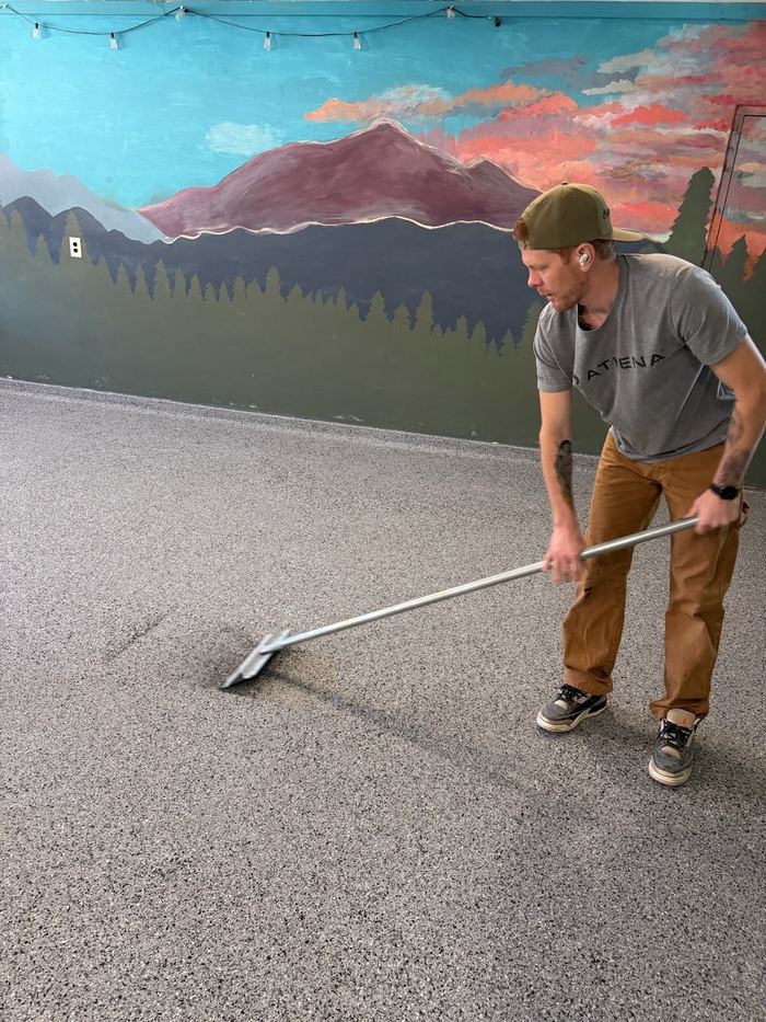 Spreading the base coat — Signature Finishes concrete coating